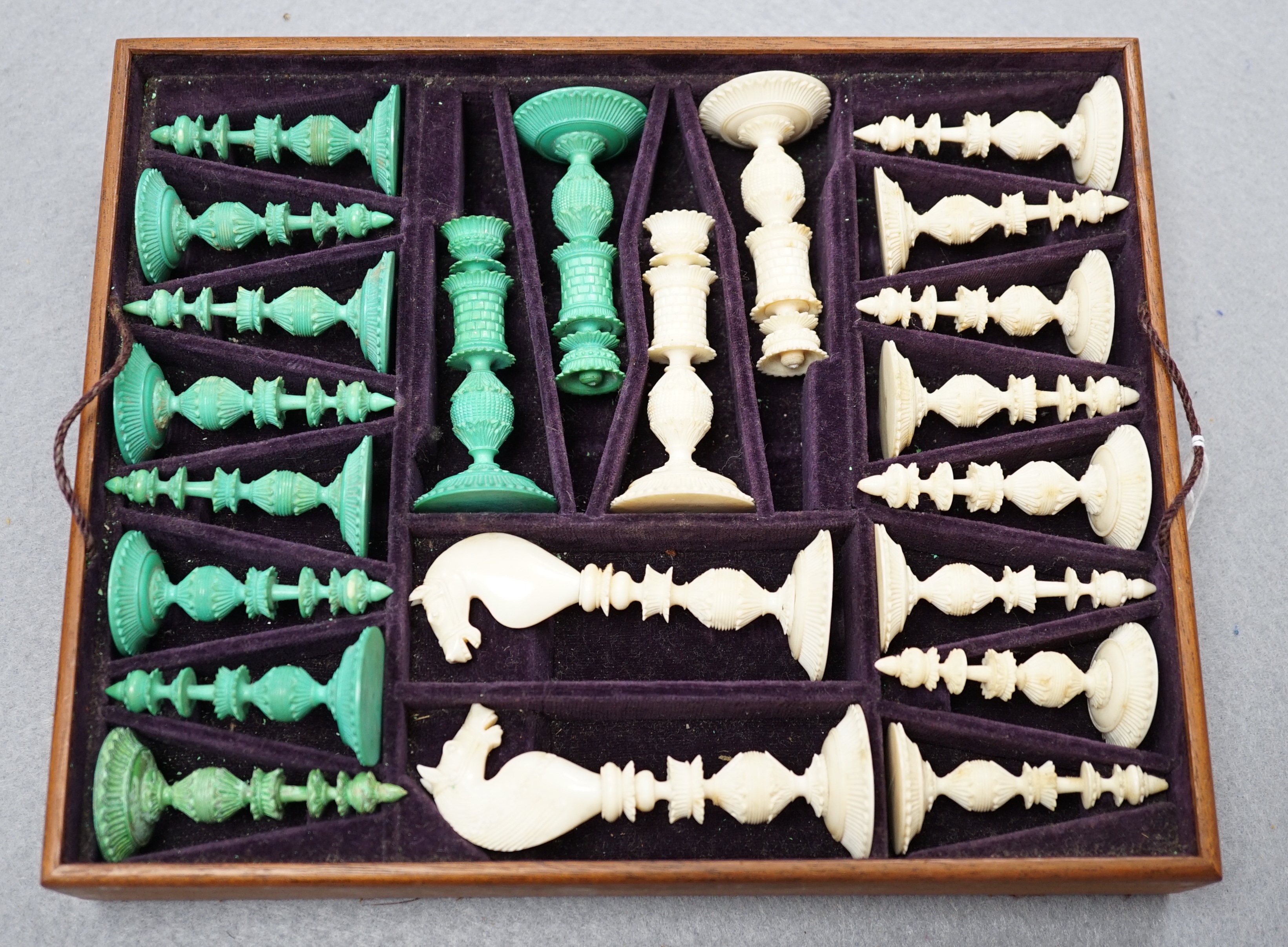 A boxed 19th century Burmese pattern ivory chess set, one pawn restored, king height 11cm